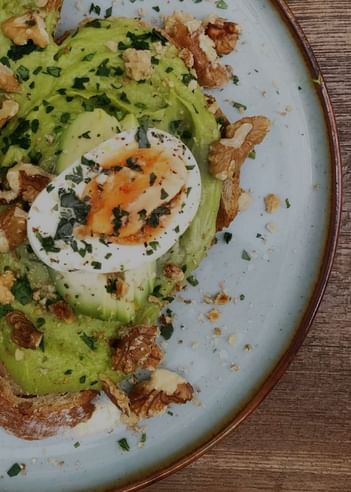 Avocado topped with walnuts and eggs dish served at Da Mariolino Restaurant