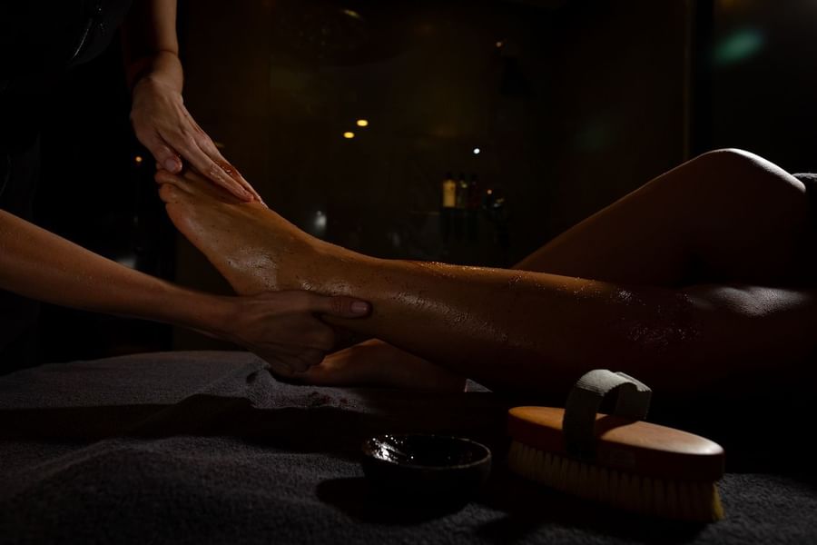 A woman having a leg massage in May Fair Spa at The May Fair Hotel