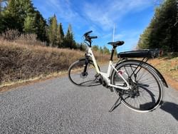 A bicycle is parked on the roadside near High Peaks Resort