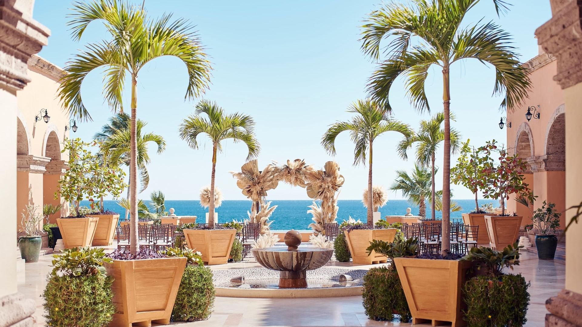 Outdoor wedding arrangements overlooking the ocean at Plazuela in Hacienda del Mar Los Cabos