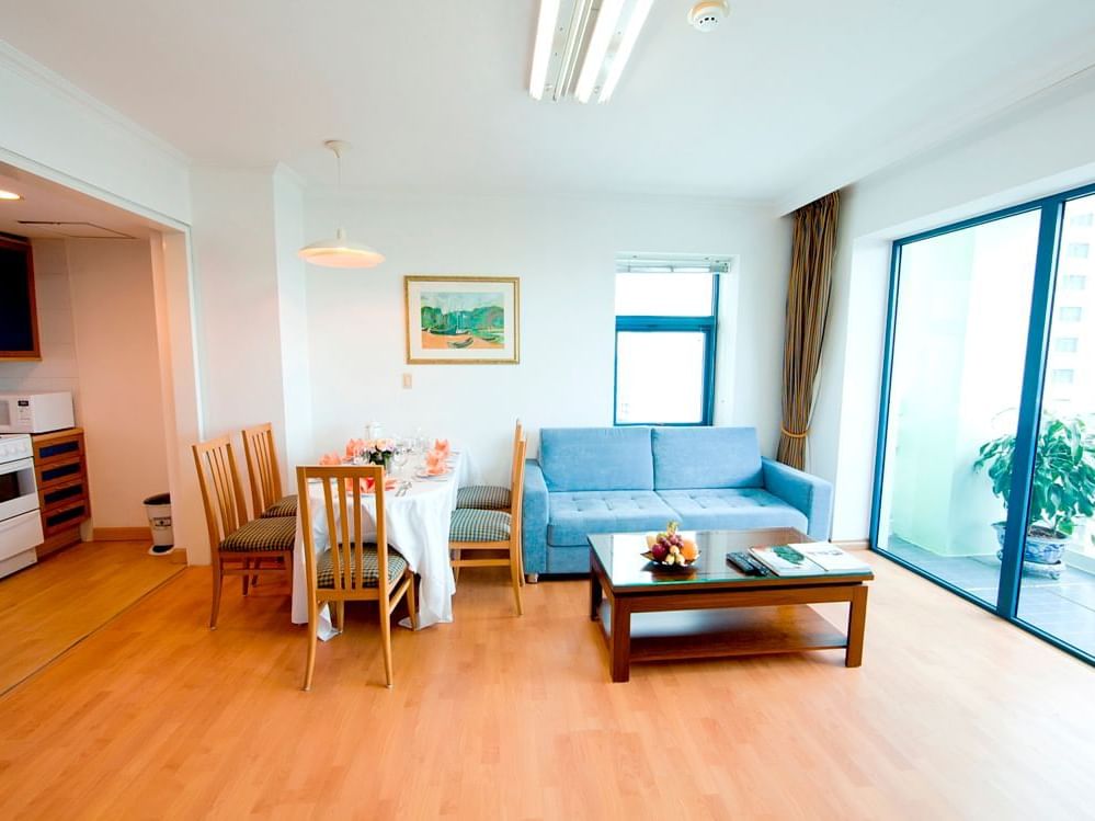 Four bedroom apartment dining table and sofa at Hanoi Daewoo Hotel
