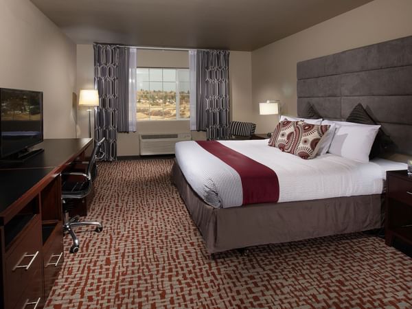 Bed in stylish hotel room with window