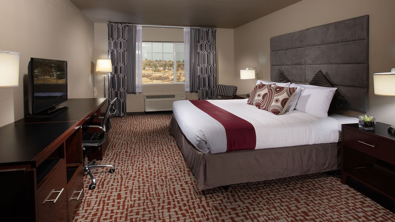 Bed in stylish hotel room with window