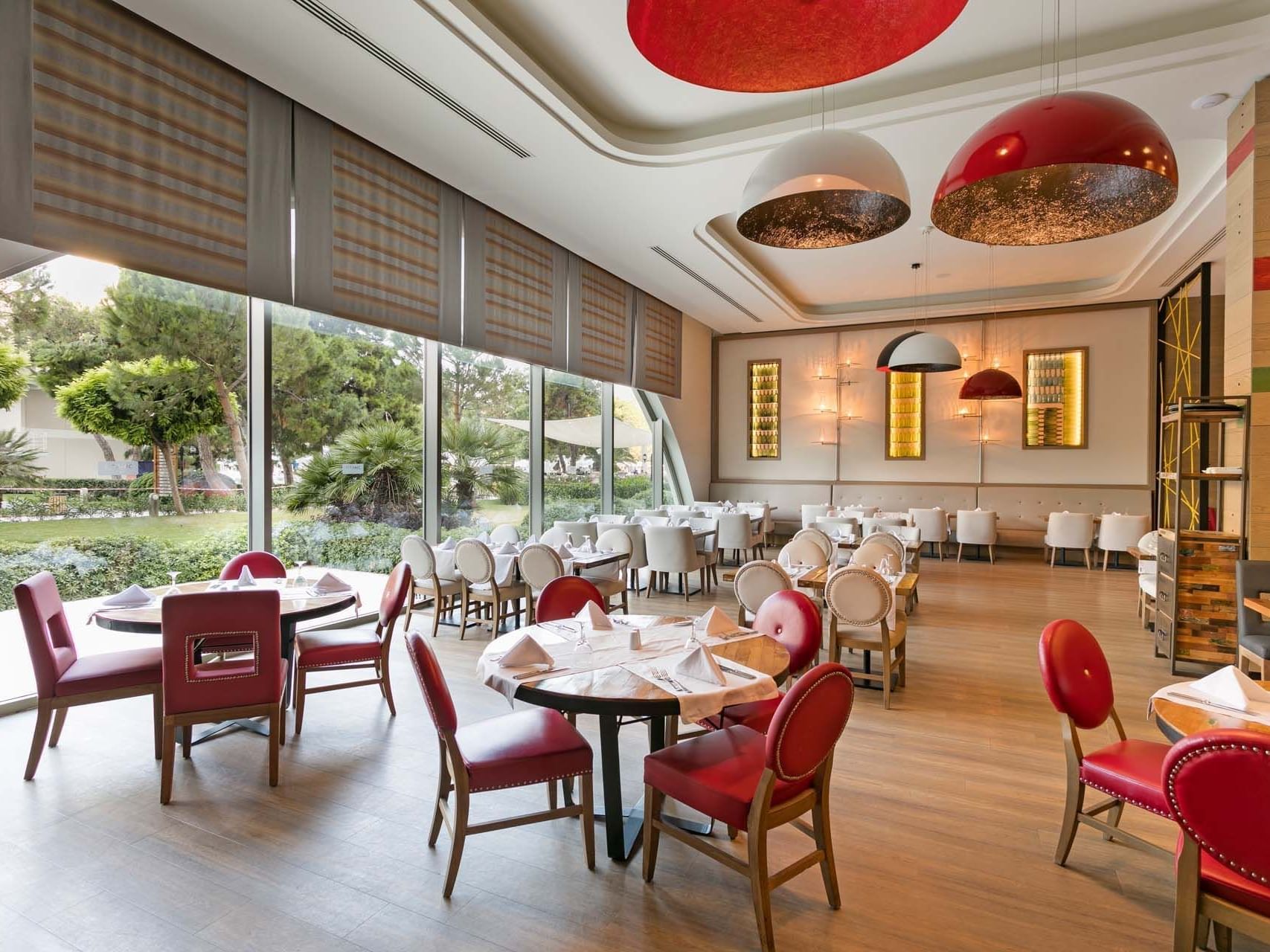 Dining tables and chairs arranged elegantly in Parkfora Main Restaurant at Titanic Deluxe Lara