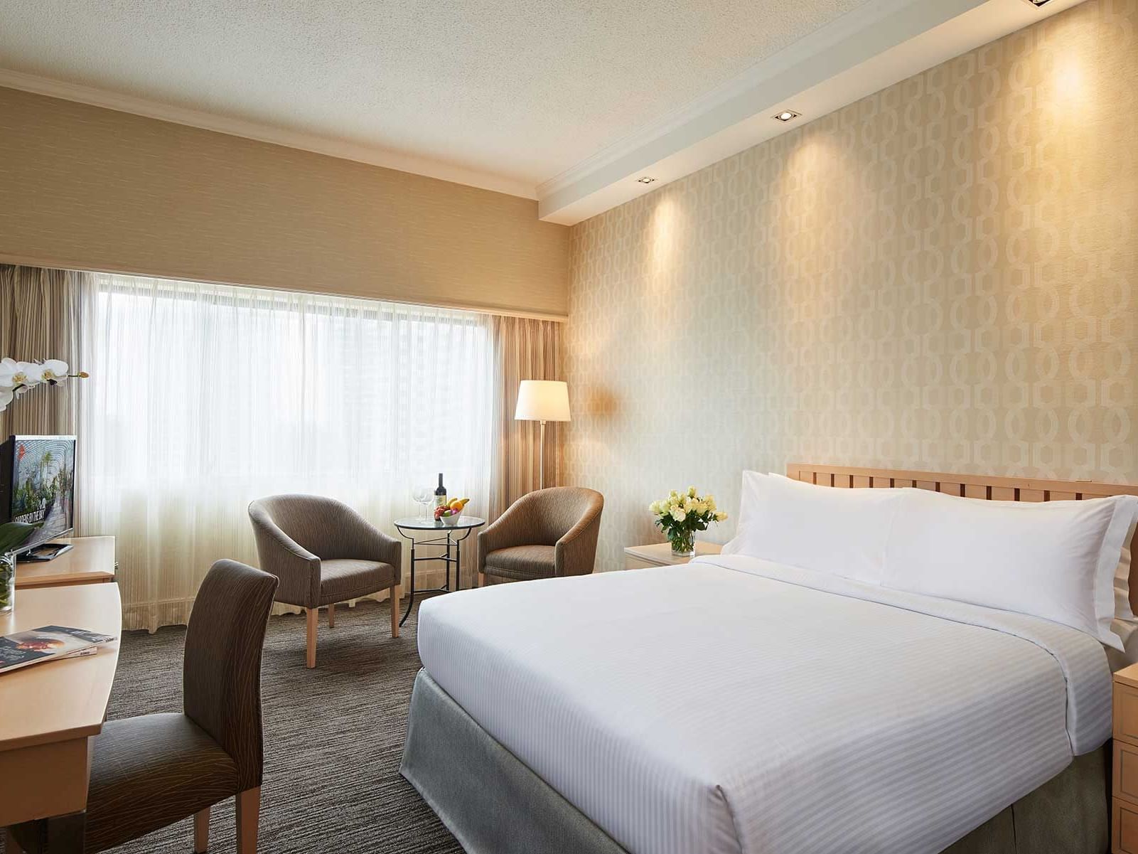 Workspace facing the bed in Superior Room with carpeted floors at York Hotel Singapore