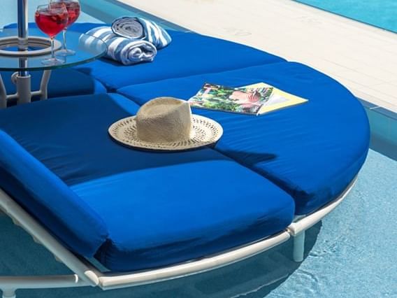 Hat & towels on a sunbed by the pool at Crown Metropol Perth