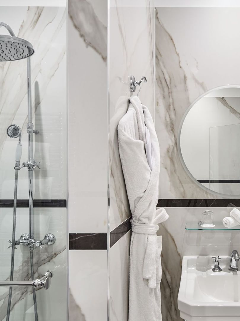 Executive Room bathroom featuring a marble vanity with a glass shower at Hotel Westminster Paris