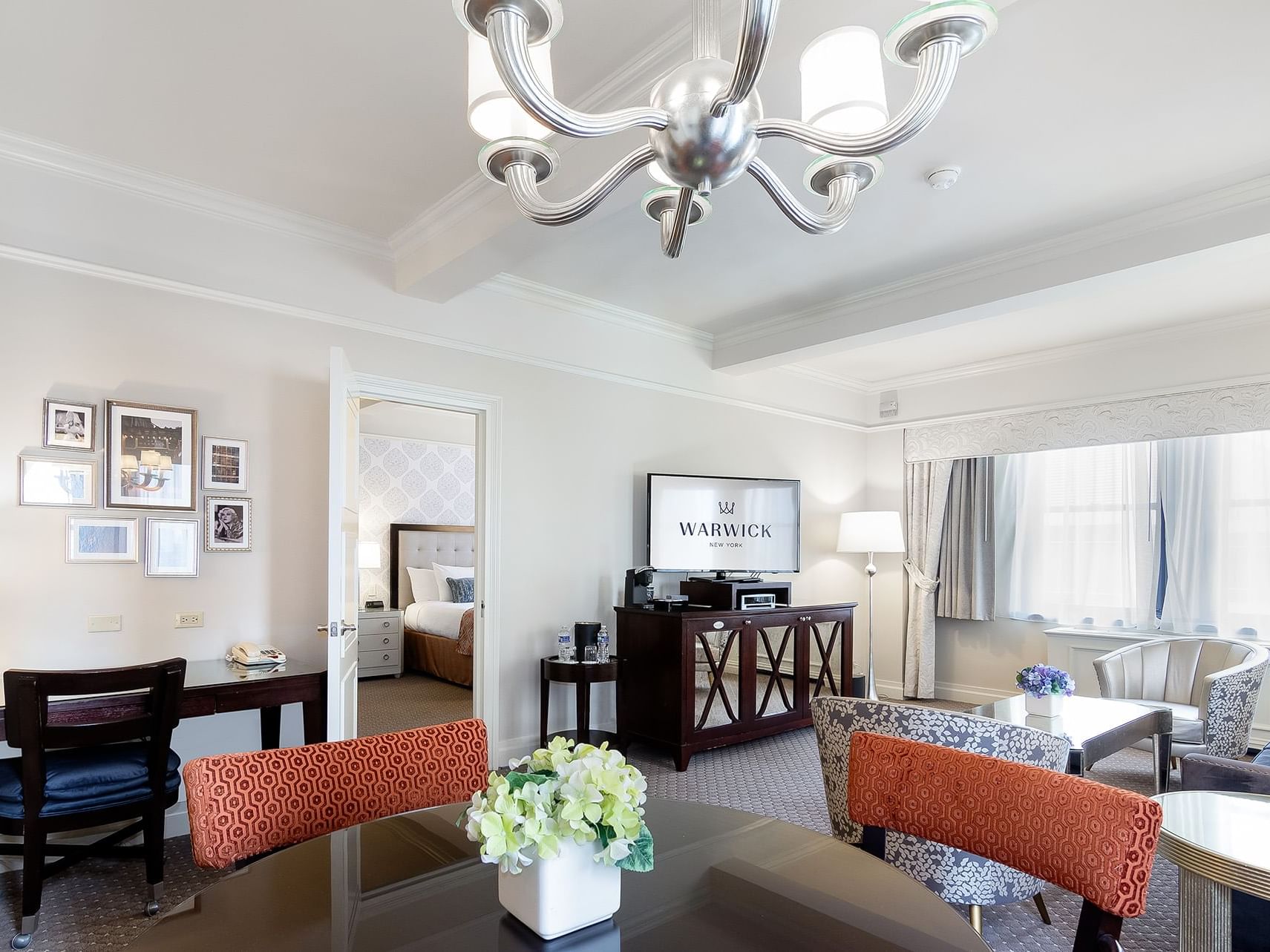 Dining area and lounge area in The Avenue One Bedroom Suite at Warwick New York