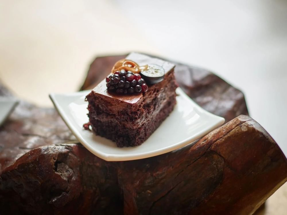 Close-up of a brownie topped with berries served in a restaurant at One Hotels