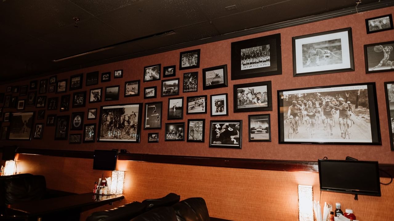 Picture frames above lounge chairs at bar