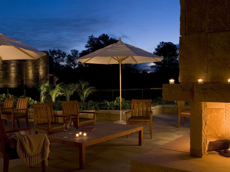 Outdoor lounge area with wooden chairs & tables at The Umstead Hotel and Spa