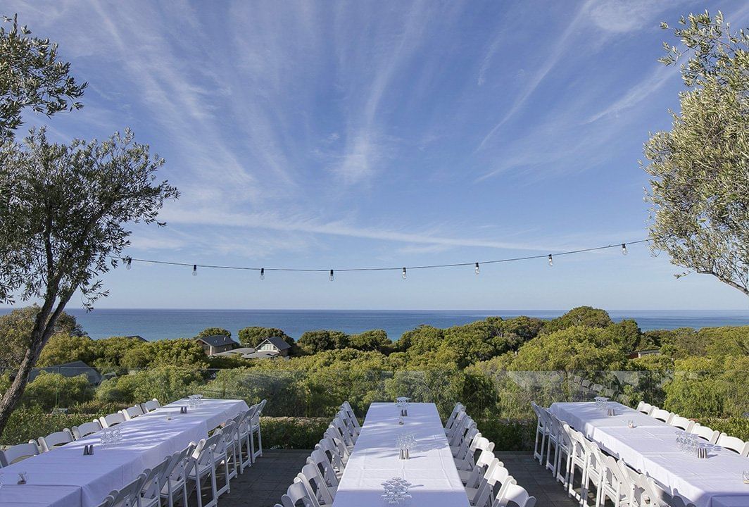 Tables setup for an event outdoors at Pullman Bunker Bay Resort