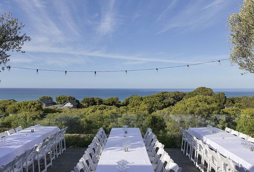 Tables setup for an event outdoors at Pullman Bunker Bay Resort