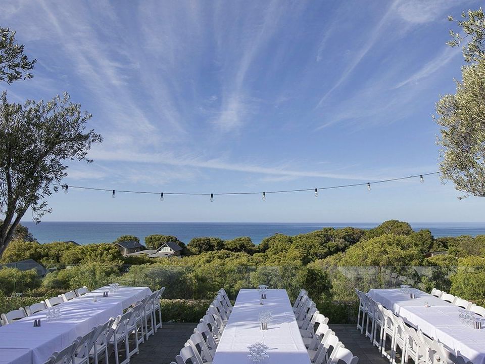 Tables setup for an event outdoors at Pullman Bunker Bay Resort