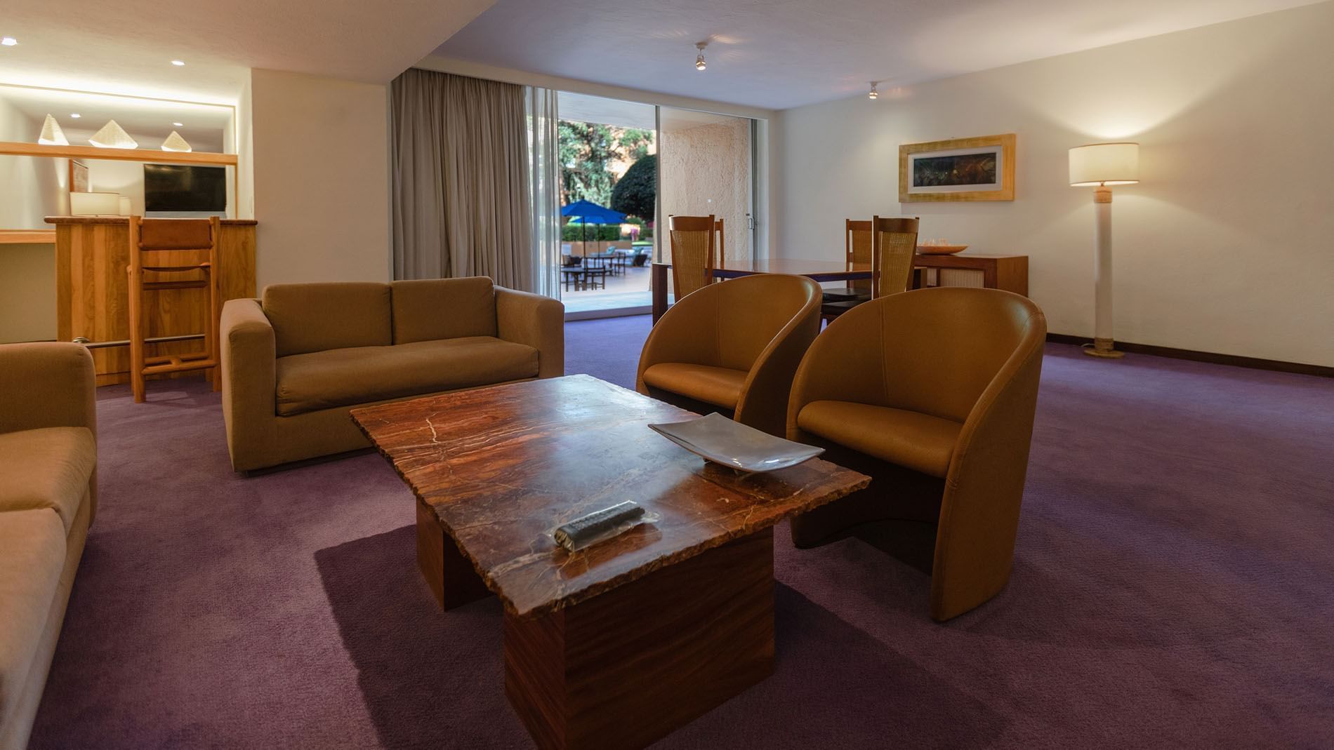 King Master Suite with a marble coffee table, purple carpet, and garden access at Camino Real Polanco Mexico
