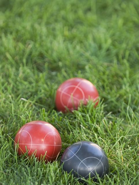 Close-up of Bocce balls on the green grass at Cove Pocono Resorts