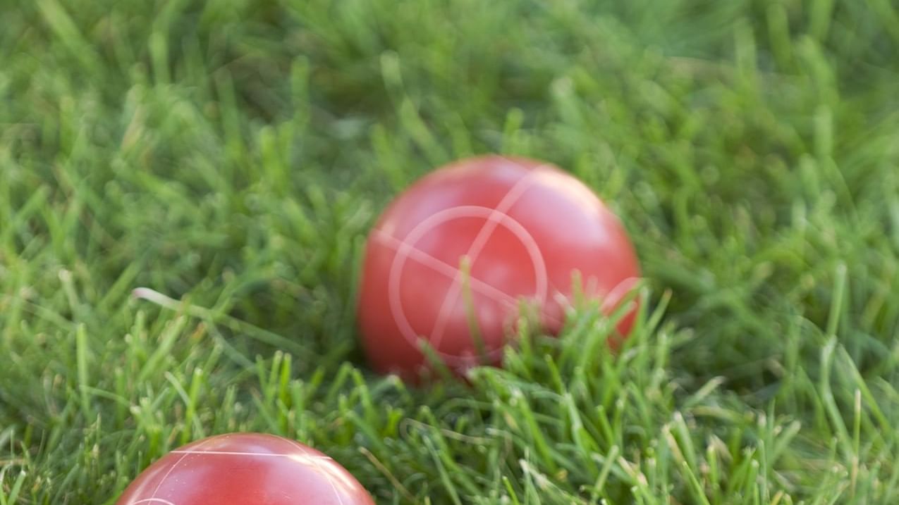Close-up of Bocce balls on the green grass at Cove Pocono Resorts