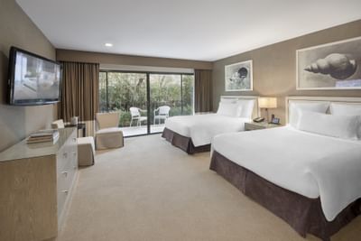 Attractive room with two double beds and a TV at Luxe Sunset