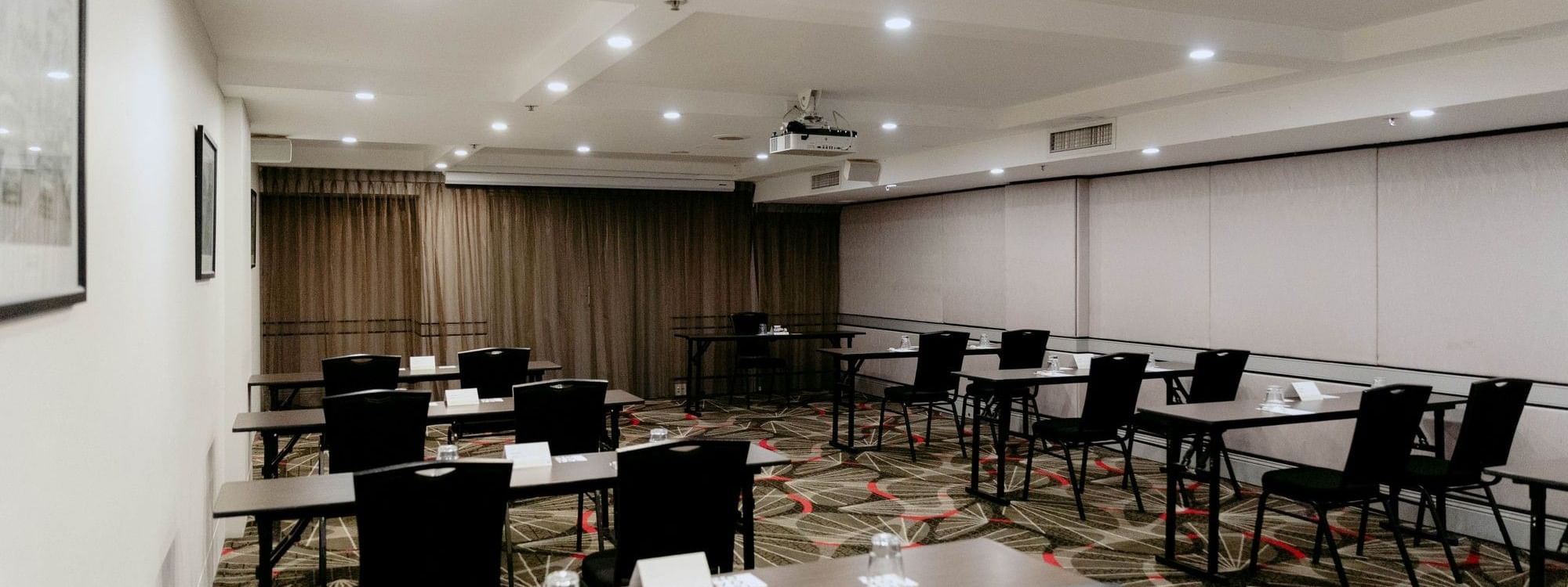 Jarrah Room event space with tables and chairs at Novotel Sydney Parramatta