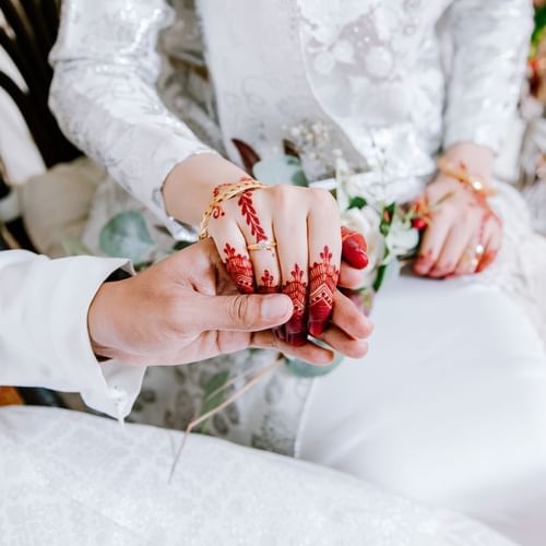 Close-up wedded couple holding hands in a Mahligai Impian wedding at One World Hotel in Petaling Jaya