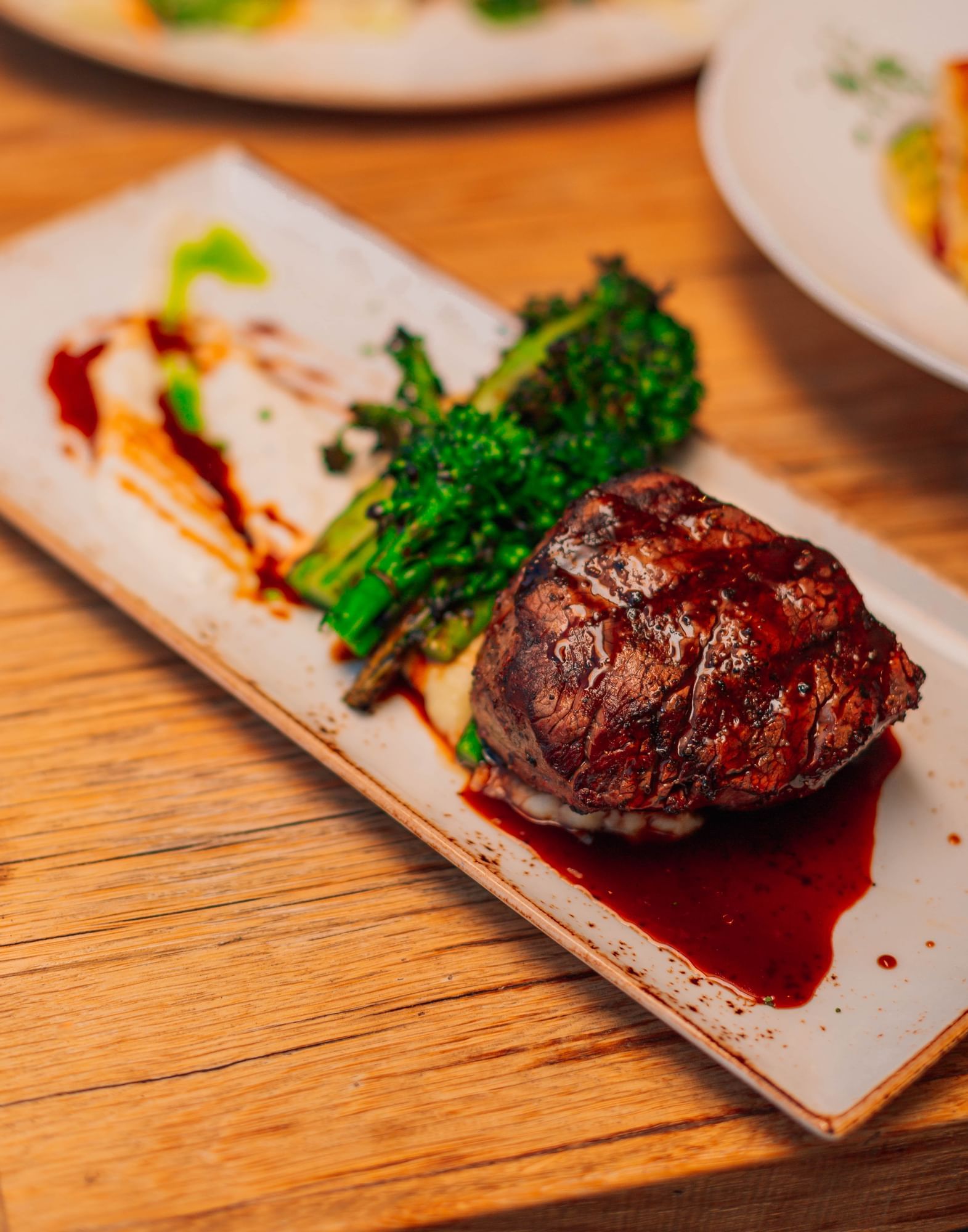 Lorem ipsum Plated steak filet and broccolini