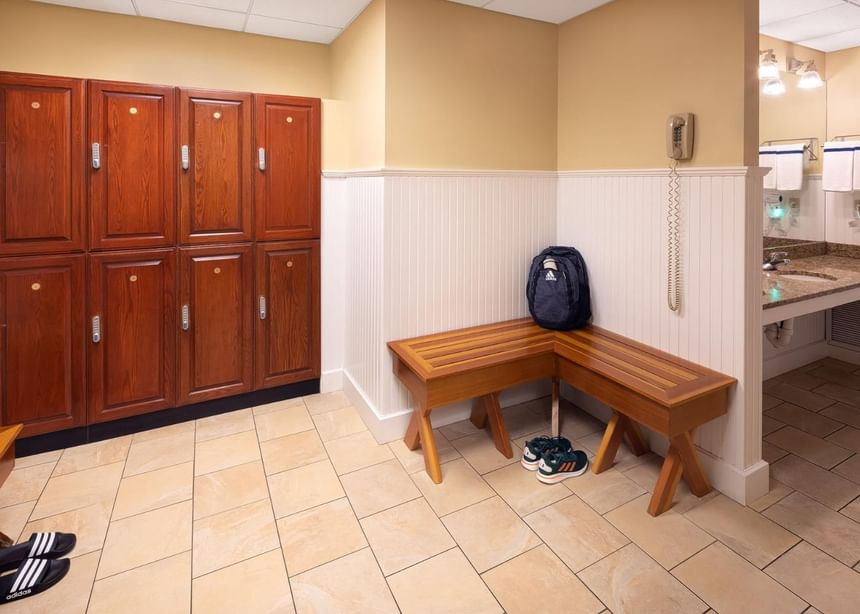 Locker room with rows of lockers, benches & bathroom vanity in Ogunquit Fitness Center near Meadowmere Resort