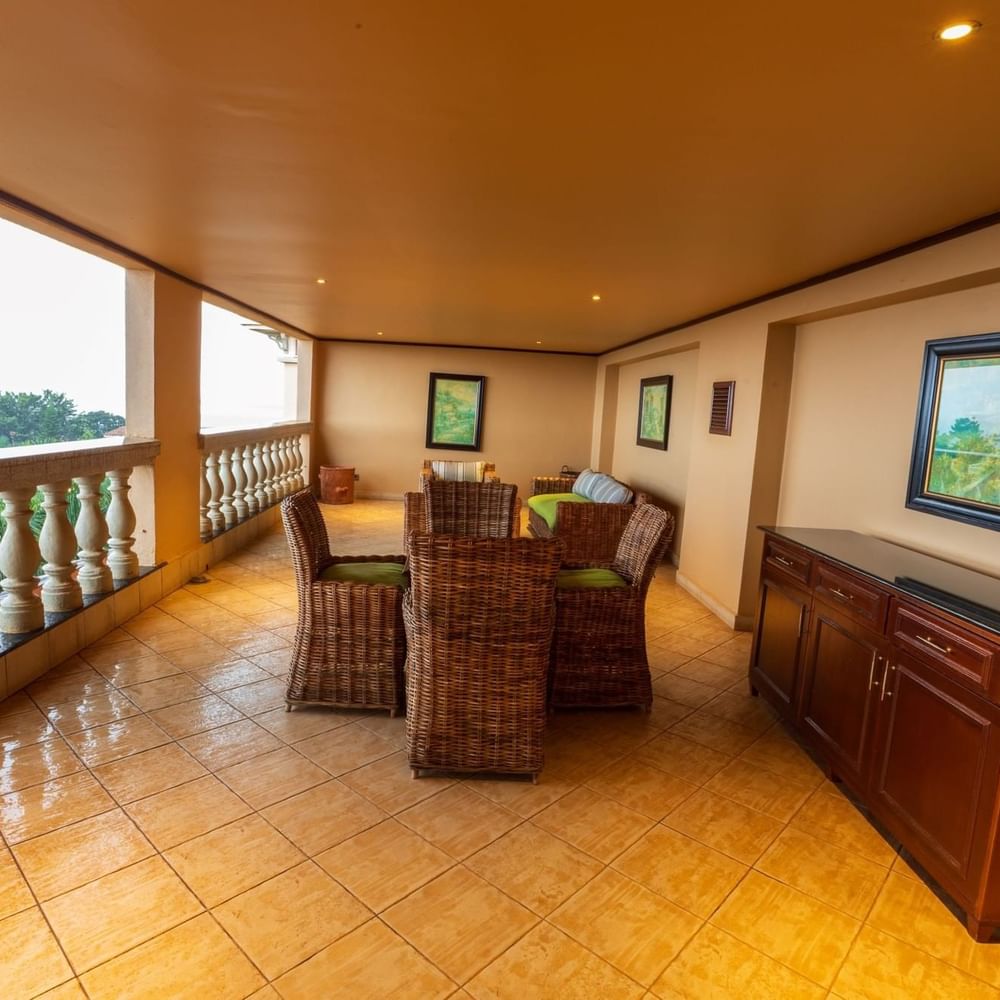 Balcony with table, chairs, and artwork at Lake Victoria Serena Golf Resort & Spa in Kampala.