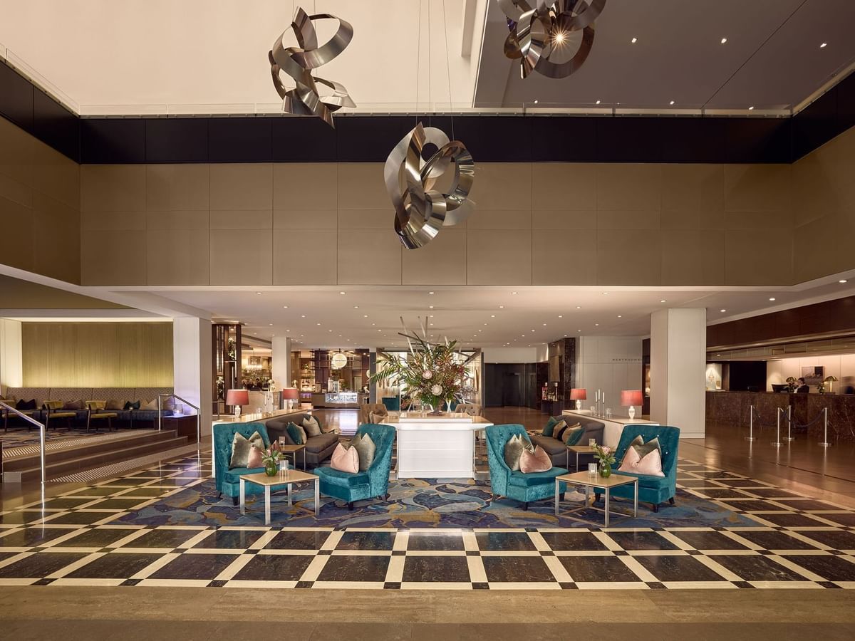 Sofitel Brisbane Central lobby with geometric floor pattern, modern furniture, and artistic ceiling fixtures