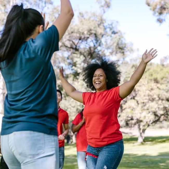 Happy employees engaging in team building activity featuring our article on 
