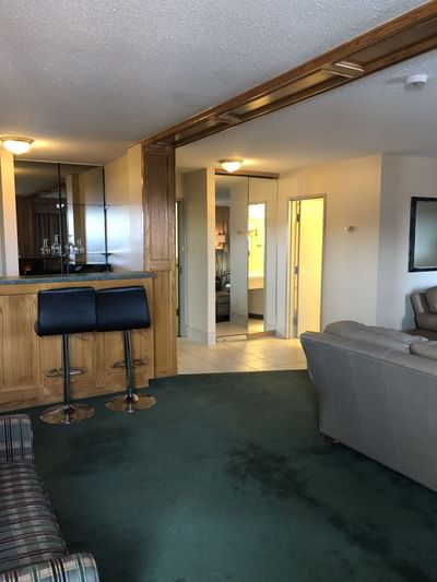 Modern living room with a bar in  One King Suite with Jetted Tub at Nomad Fort McMurray
