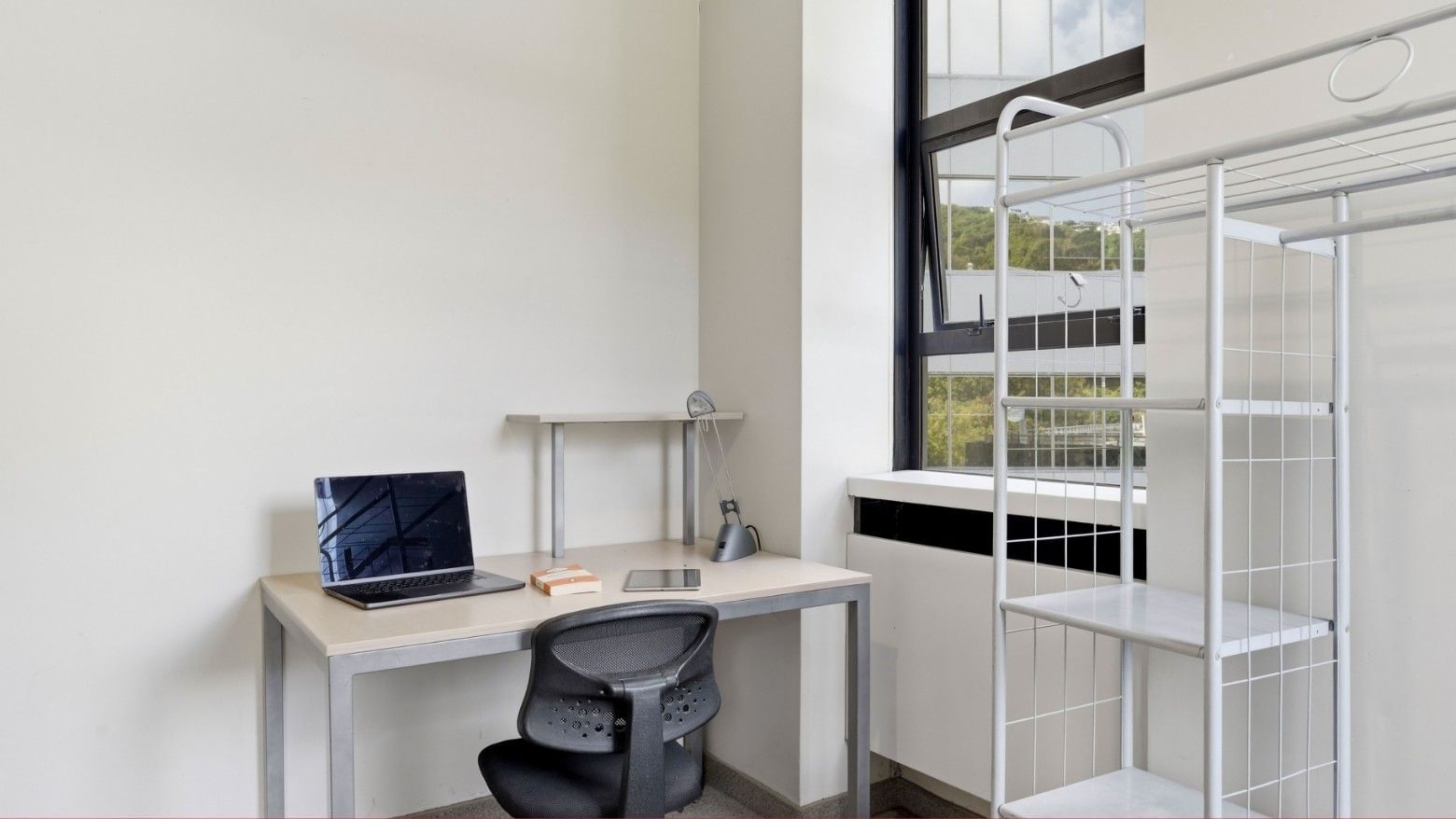 Office room with desk, laptop, and storage shelving at UniLodge Stafford House.