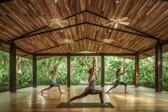 Ladies doing Yoga in an open space at Cala Luna Boutique Hotel