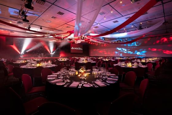 Red themed banquet set-up in Federation Ballroom with low light conditions at Hotel Grand Chancellor Hobart
