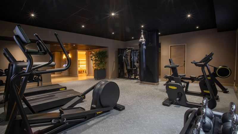 Technogym cardio equipment with a view of the sauna entrance at Warwick Reine Astrid - Lyon