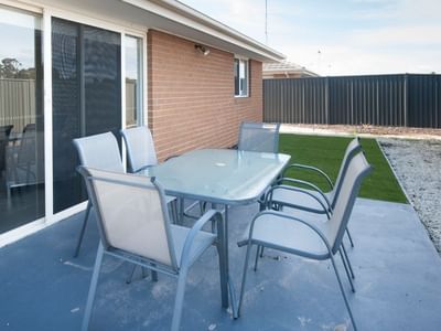 Outdoor dining area with table and chairs at La Trobe University Regional Housing – Shepparton.
