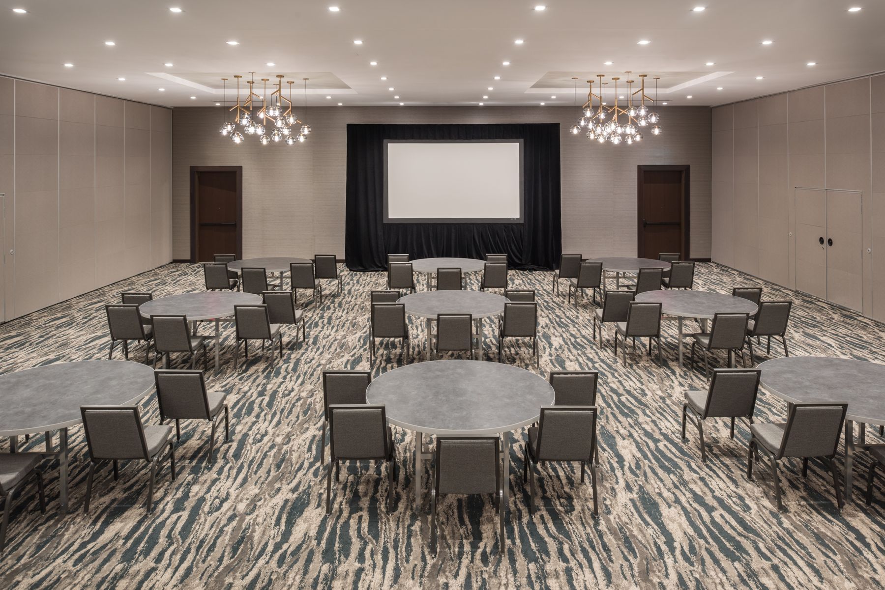 Meeting space set with banquet rounds
