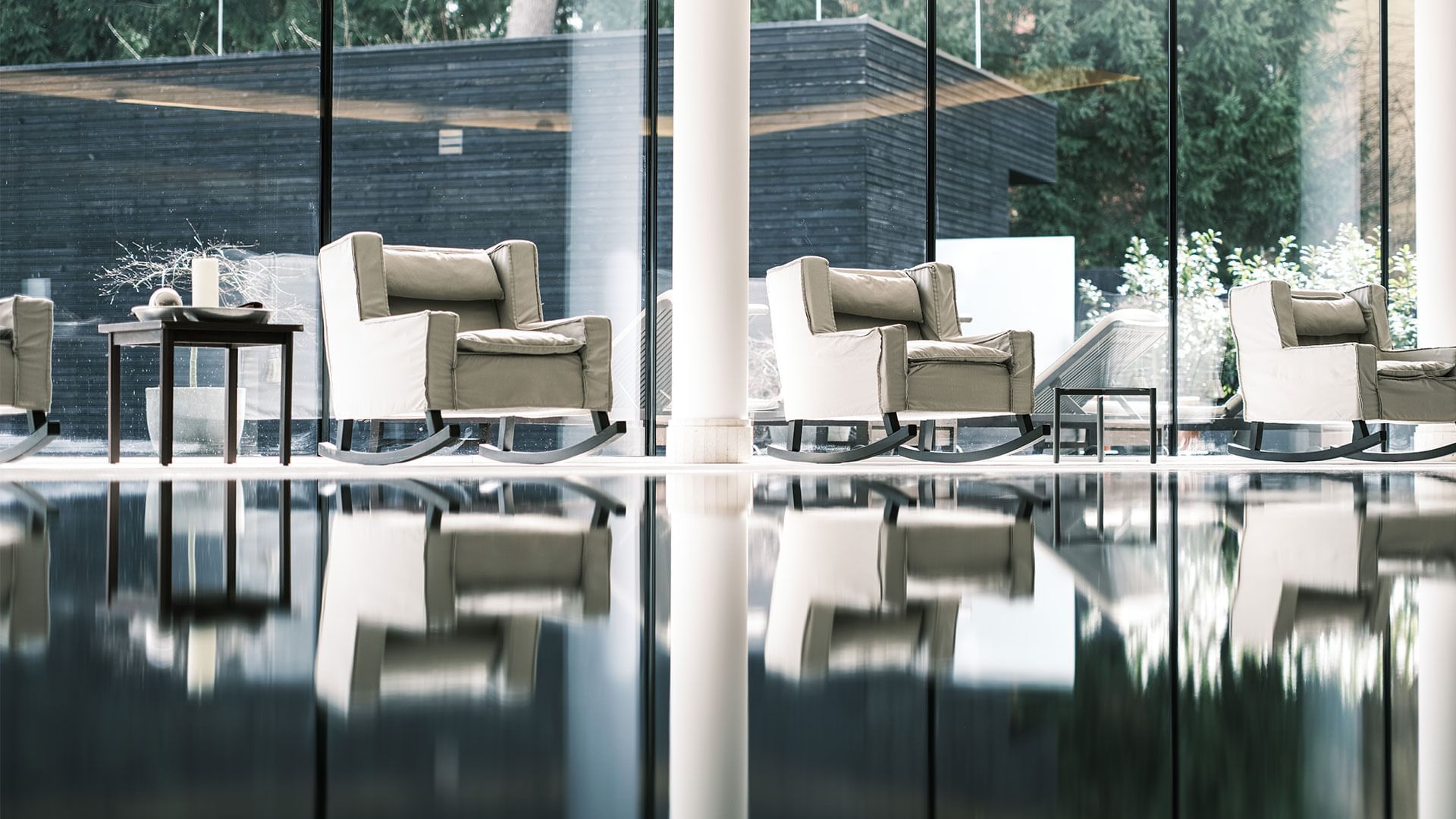 Lounge chairs by the indoor pool area at Falkensteiner Schlosshotel Velden