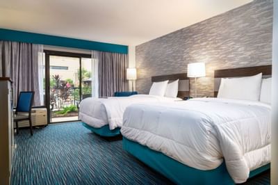 Twin beds in Double pool-side balcony at MCM Elegante Beaumont