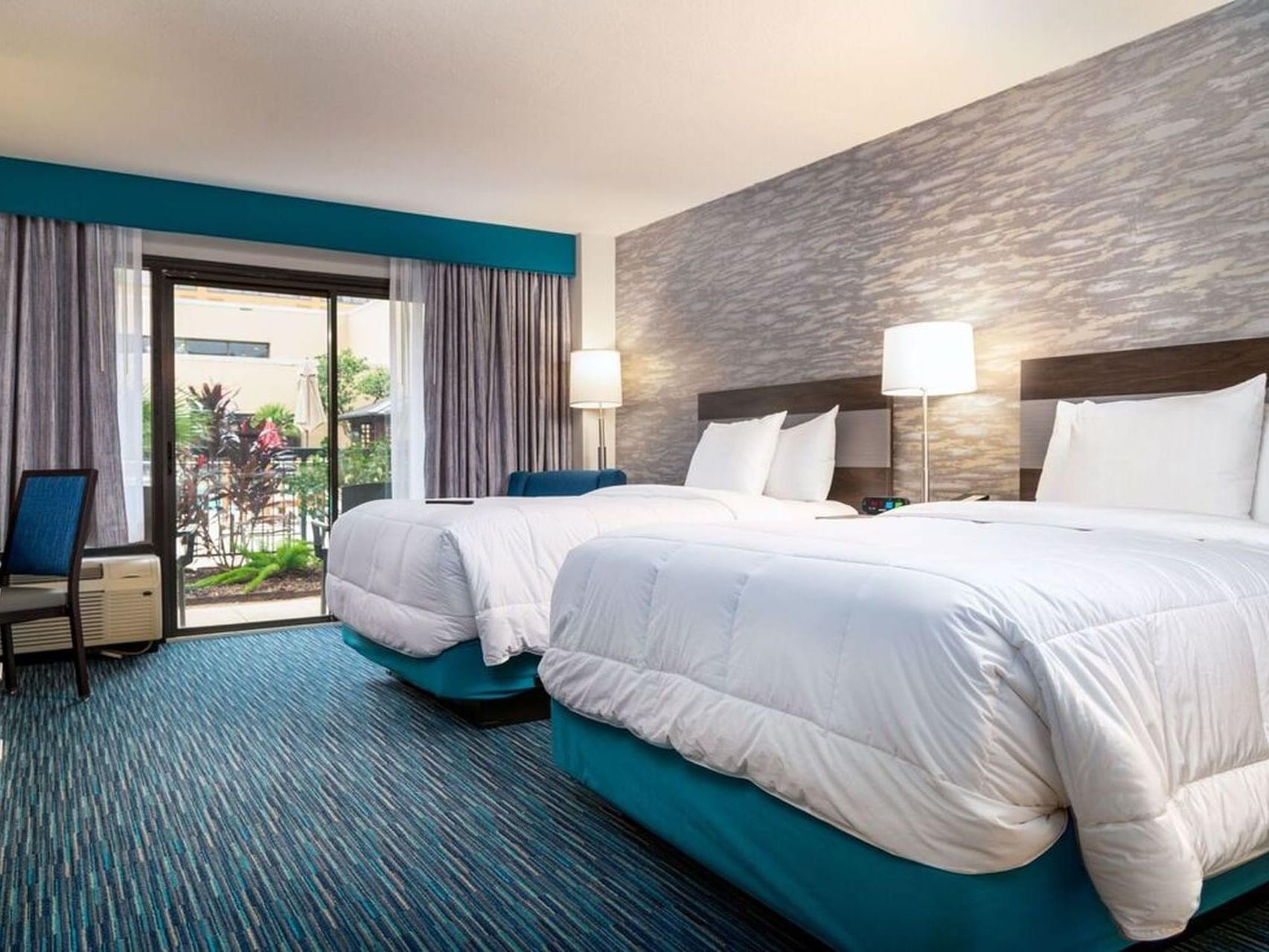 Twin beds in Double pool-side balcony at MCM Elegante Beaumont