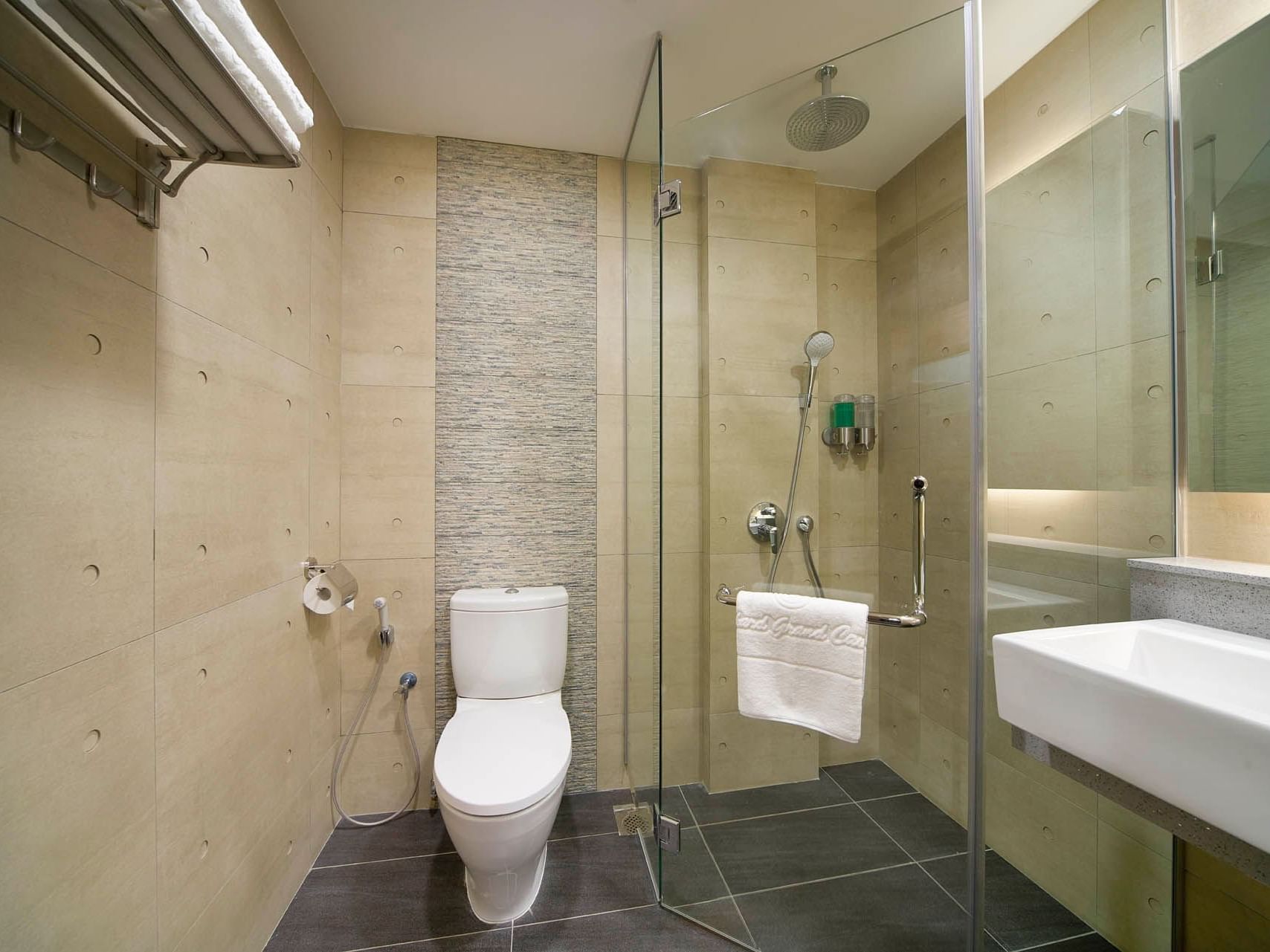 Image 76: Modern Two Bedroom bathroom with a glass shower, sleek sink, toilet and neutral-toned tiles at Orchard Grand Court