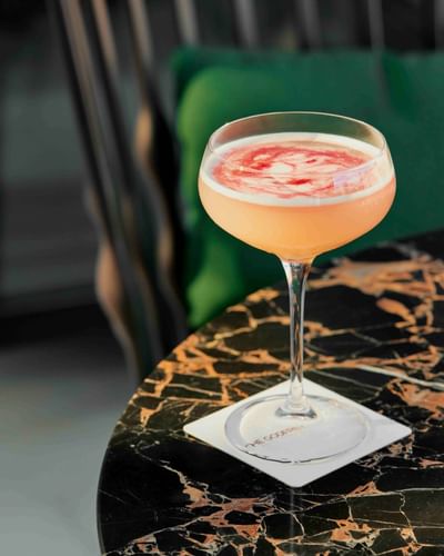 Close-up of a cocktail served on a marble table at Godfrey Hotel Detroit