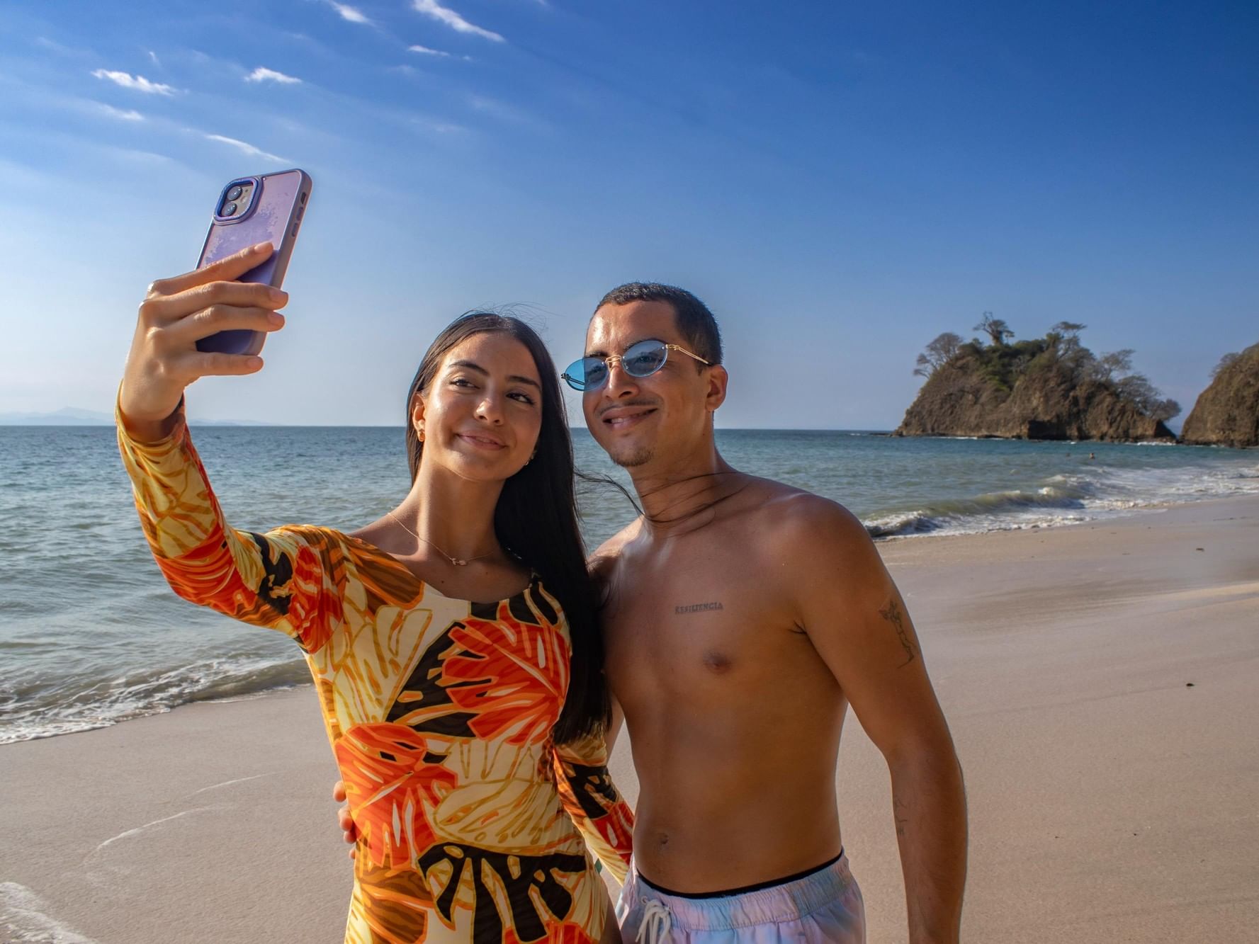 Couple on the beach taking a selfie for the Nature & Beach Escape offer.