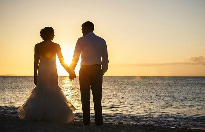 Couple holding hands on the beach, The Somerset On Grace Bay