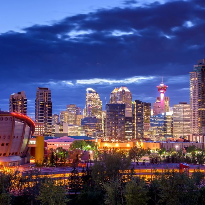 A stunning cityscape under the night sky near Acclaim Hotel Calgary