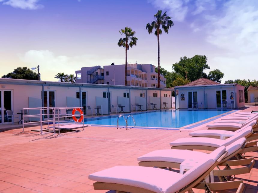Exterior view of outdoor swimming pool at Cavomarina hotel