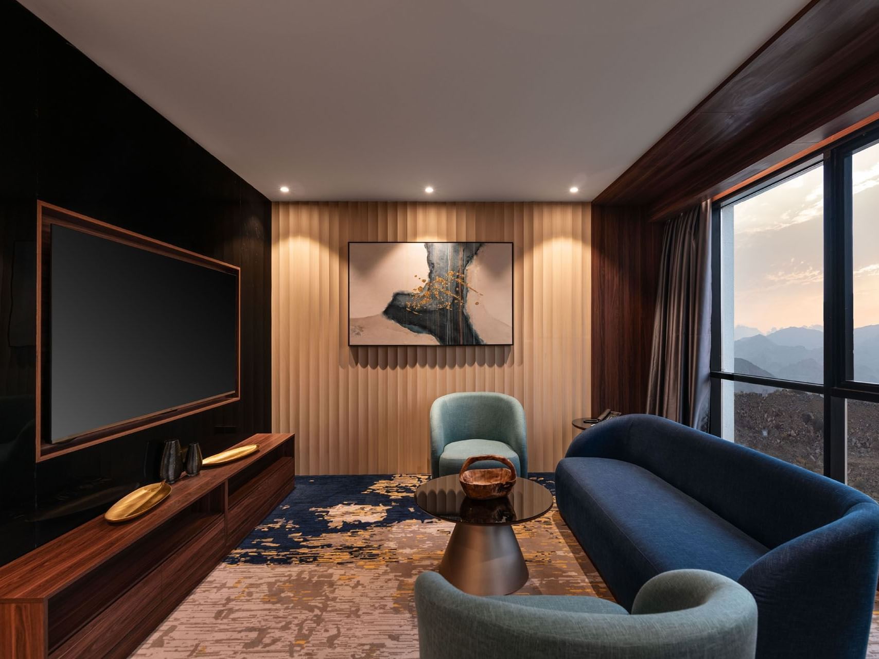 Living area with sofa, TV, and mountain view in Royal Suite at Warwick Hotels & Resorts