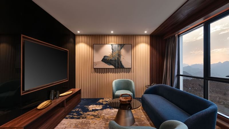 Living area with sofa, TV, and mountain view in Royal Suite at Warwick Hotels & Resorts