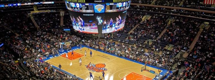 A basketball game in Madison Square Garden surrounded by crowd near Warwick New York