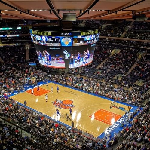 A basketball game in Madison Square Garden surrounded by crowd near Warwick New York