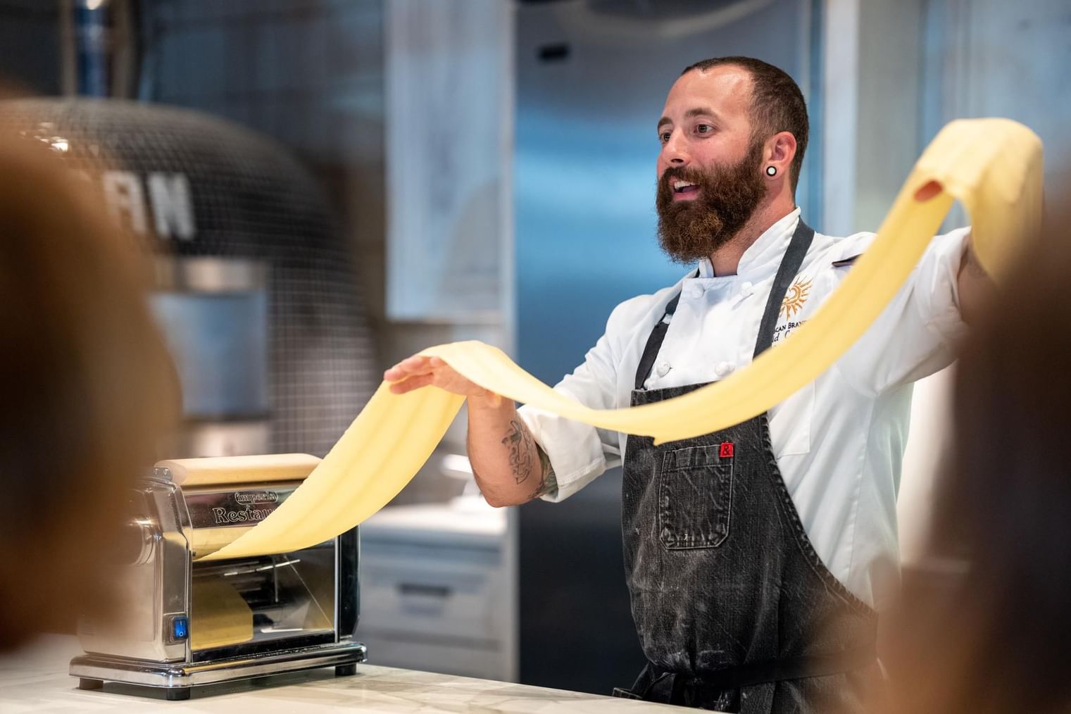 Chef Dave rolling a fresh pasta dough in a restaurant at The Artisan Hotel at Tuscan Village
